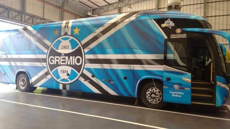 O ônibus do Grêmio é tricolor: preto, branco e azul, em sua maior parte.