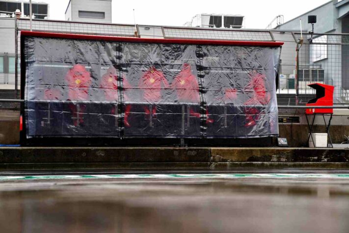 Membros do pit-wall da Ferrari se protegeram da chuva na Alemanha 